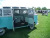 Side of a two-tone VW Bus with its doors open