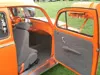 Orange VW Beetle with its door open