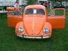 Front of an orange VW Beetle with its doors open