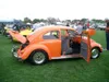 Side of an orange VW Beetle with its door open